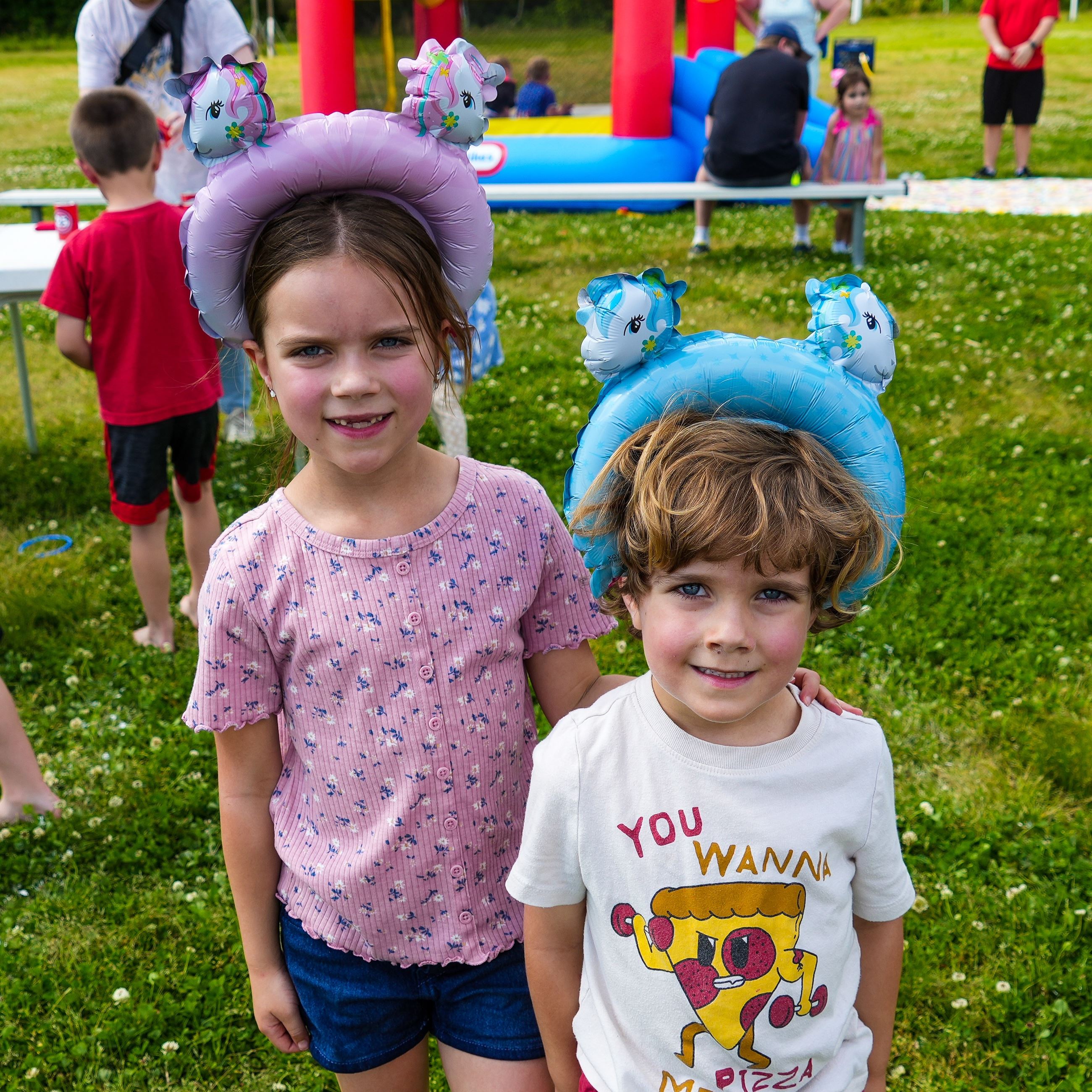 Two kids posing with silly headbands