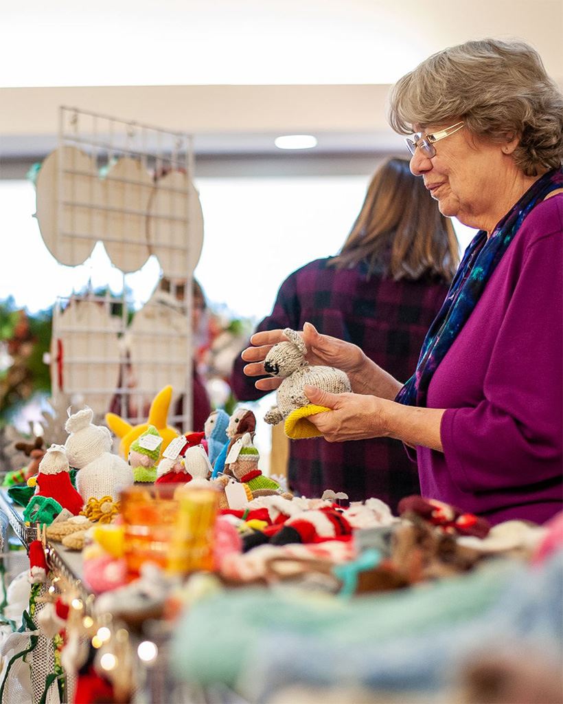 Crafter selling her crocheted items.