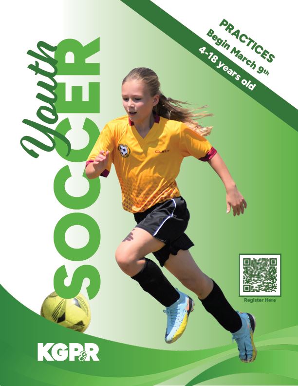 Girl in a yellow soccer jersey running and kicking a soccer ball.